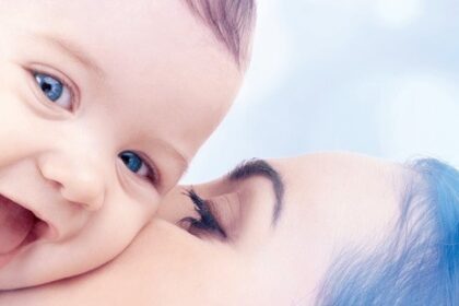 mom kissing baby