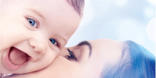 mom kissing baby
